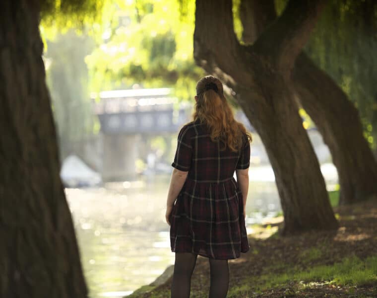 image of woman looking at riverside in Norwich