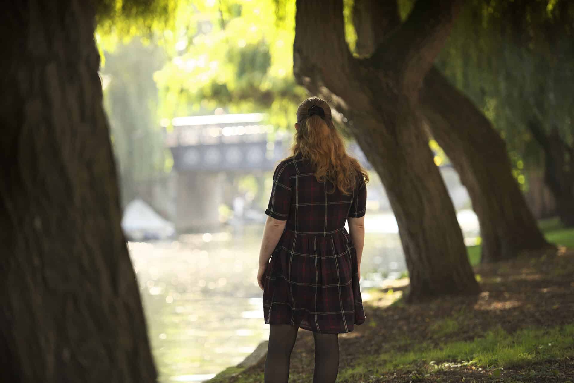 image of woman looking at riverside in Norwich